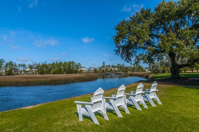 dock area with a water view and a lawn