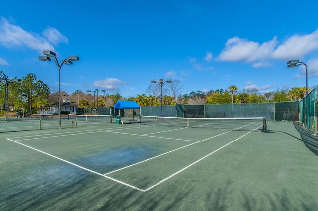 view of tennis court featuring fence