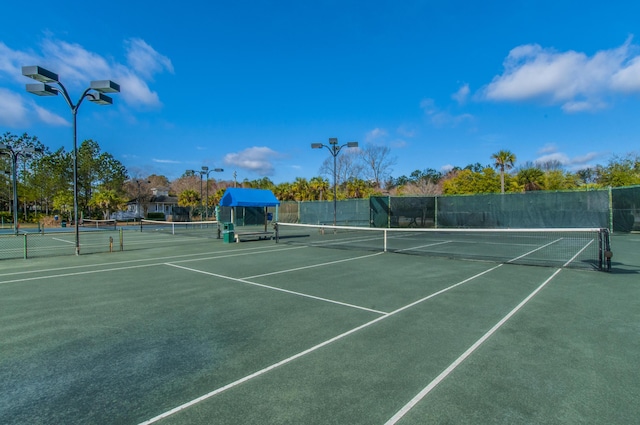 view of sport court featuring fence