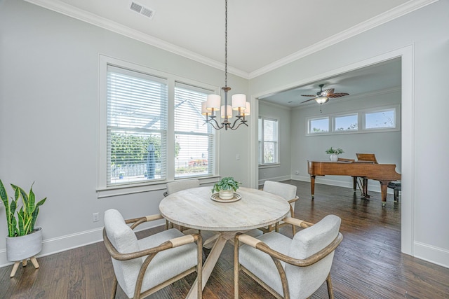 dining space with dark wood-type flooring, a healthy amount of sunlight, and crown molding