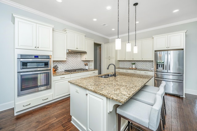 kitchen featuring dark wood-type flooring, crown molding, stainless steel appliances, and a sink