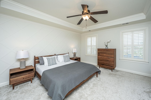 carpeted bedroom featuring visible vents, crown molding, baseboards, and ceiling fan