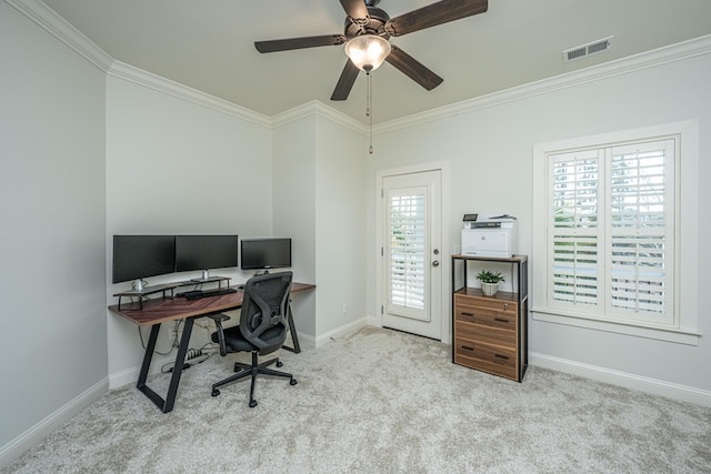 carpeted home office featuring baseboards, ceiling fan, visible vents, and crown molding