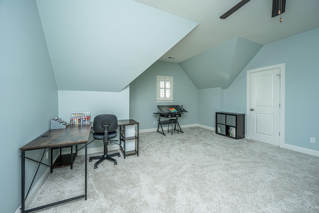 carpeted office with lofted ceiling, a ceiling fan, and baseboards