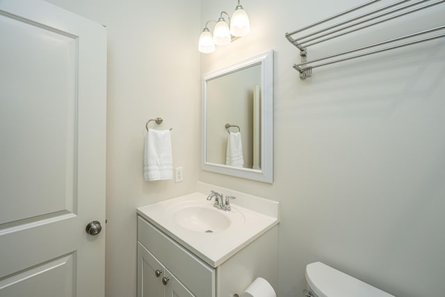 half bath with vanity and toilet