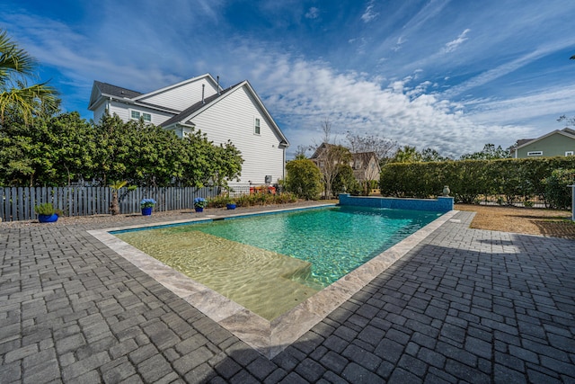 view of swimming pool with a fenced in pool, a patio, and fence