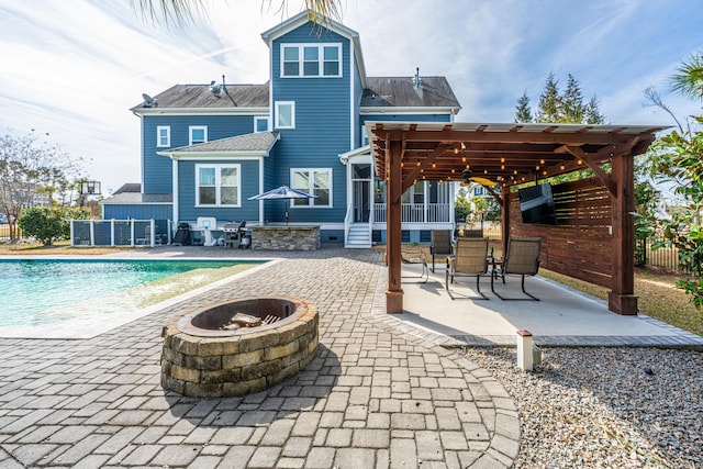 back of house featuring a patio area, fence, an outdoor pool, and a pergola