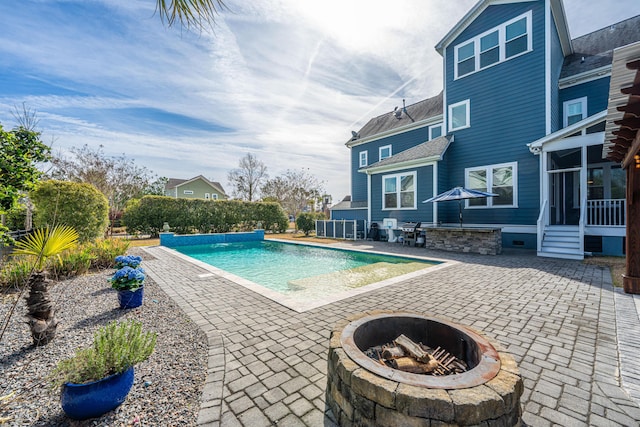 view of swimming pool featuring a fenced in pool, an outdoor fire pit, and a patio