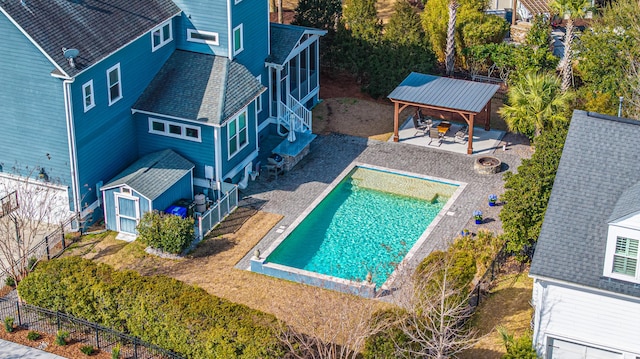 view of pool featuring a fenced in pool, a gazebo, a patio area, a fenced backyard, and a fire pit