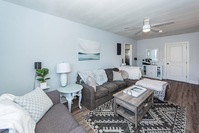 living room featuring ceiling fan and hardwood / wood-style flooring