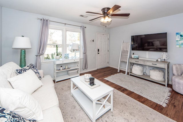 living room featuring hardwood / wood-style flooring and ceiling fan