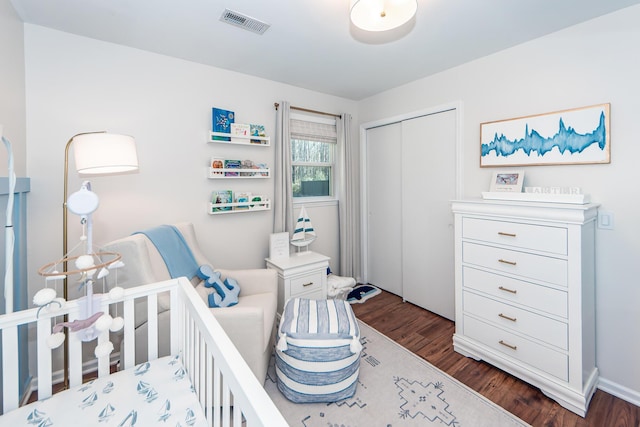 bedroom with a closet and dark hardwood / wood-style floors