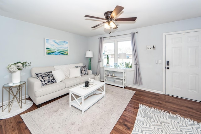 living room with ceiling fan and dark hardwood / wood-style flooring