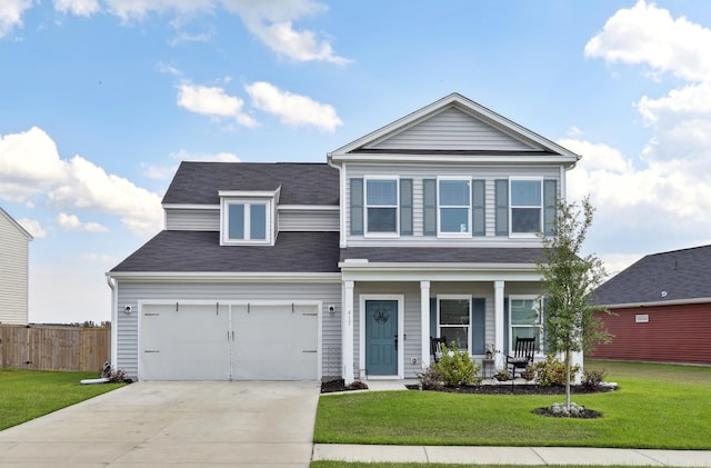 view of front of property with a front yard, a garage, and covered porch