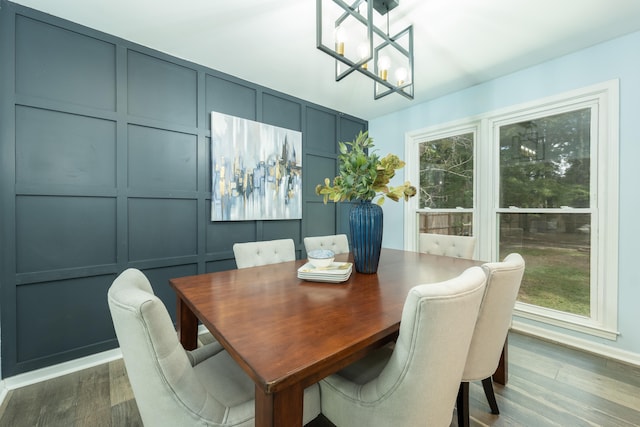 dining room with dark hardwood / wood-style flooring and a notable chandelier