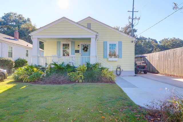 bungalow-style house with covered porch and a front yard