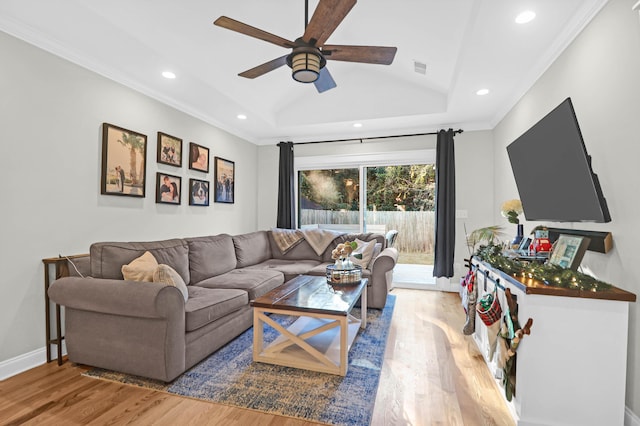 living room featuring wood-type flooring, vaulted ceiling, ceiling fan, and ornamental molding