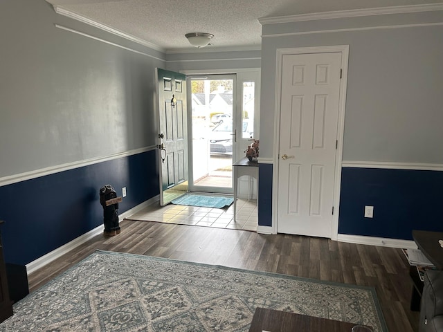 foyer entrance featuring hardwood / wood-style floors, crown molding, and a textured ceiling