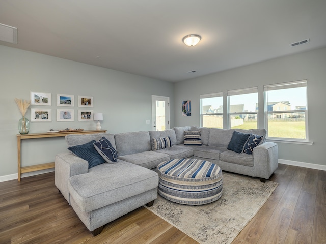 living room with dark hardwood / wood-style flooring