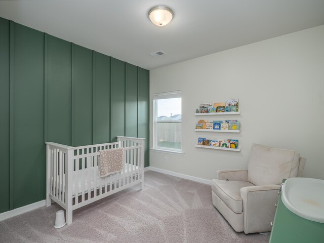 carpeted bedroom with a crib