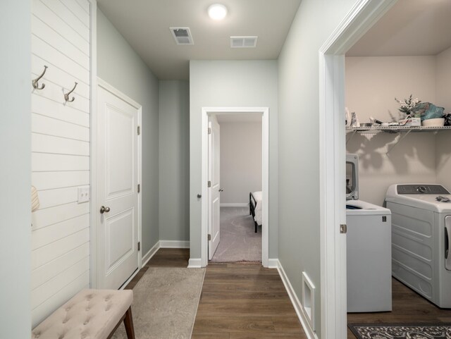 mudroom with dark hardwood / wood-style flooring and independent washer and dryer