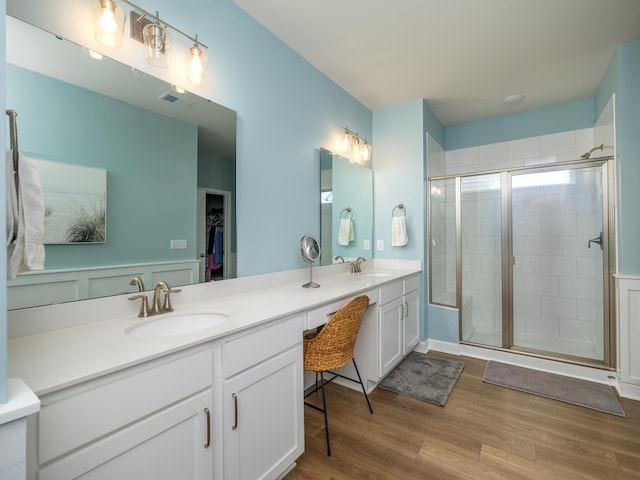 bathroom with vanity, wood-type flooring, and walk in shower