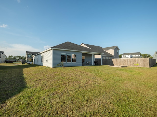 rear view of house with a yard