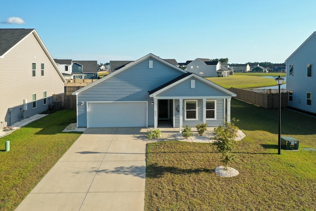 view of front of home featuring a garage, a front yard, and central AC