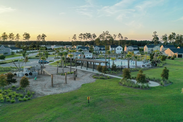 exterior space featuring a playground and a yard