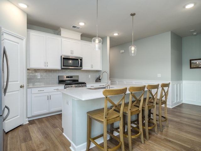 kitchen with stainless steel appliances, sink, dark hardwood / wood-style floors, and white cabinetry