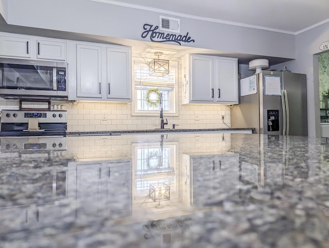 kitchen featuring stainless steel appliances, crown molding, sink, white cabinetry, and backsplash