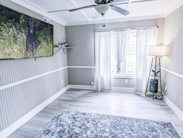 spare room featuring ceiling fan, crown molding, and wood-type flooring