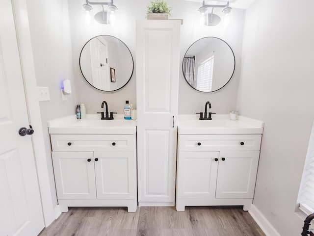 bathroom with vanity and wood-type flooring