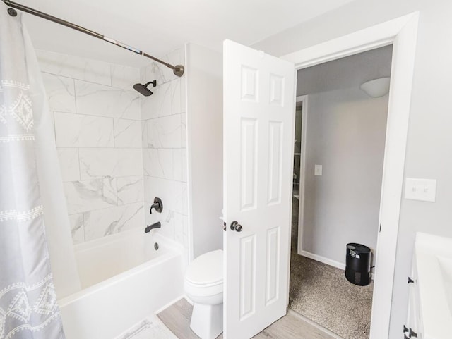 bathroom featuring toilet, shower / bath combination with curtain, and hardwood / wood-style flooring