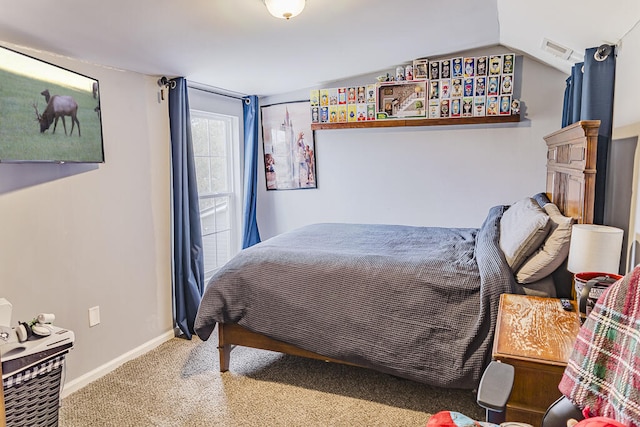 bedroom with vaulted ceiling and carpet flooring