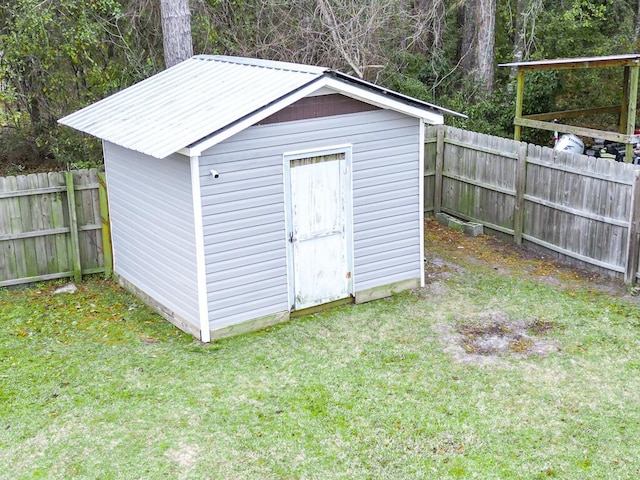 view of outbuilding featuring a lawn