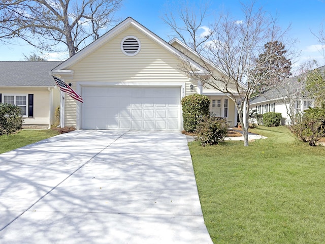 view of front facade with an attached garage, concrete driveway, and a front yard