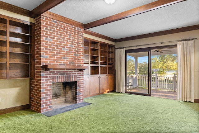 unfurnished living room with a textured ceiling, beamed ceiling, ceiling fan, a fireplace, and carpet