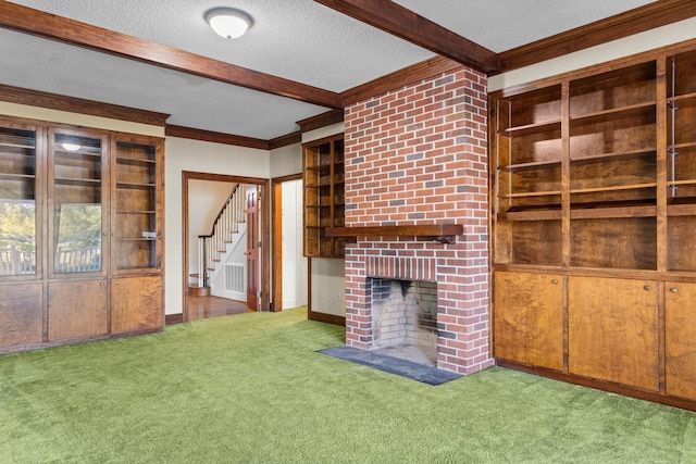 unfurnished living room featuring beamed ceiling, stairway, a fireplace, crown molding, and carpet floors