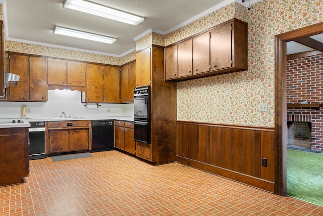 kitchen featuring black appliances, brick patterned floor, wallpapered walls, and wainscoting