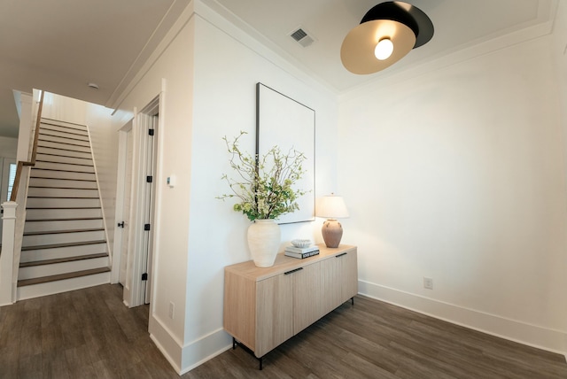 hall with crown molding and dark hardwood / wood-style flooring