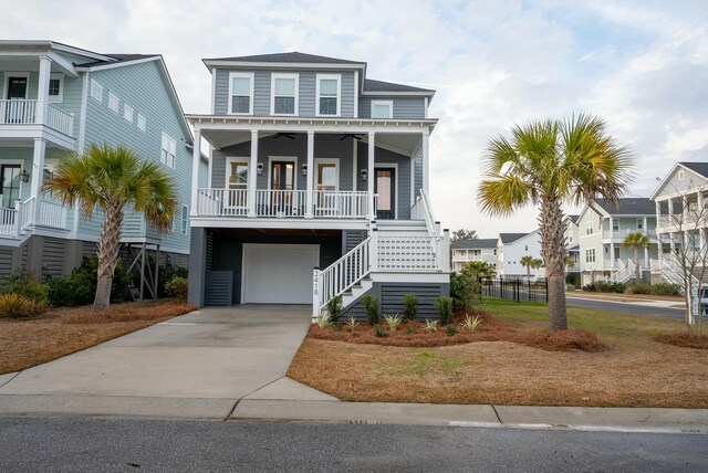 raised beach house featuring a garage, ceiling fan, and a porch