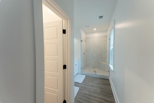 bathroom featuring an enclosed shower and hardwood / wood-style floors