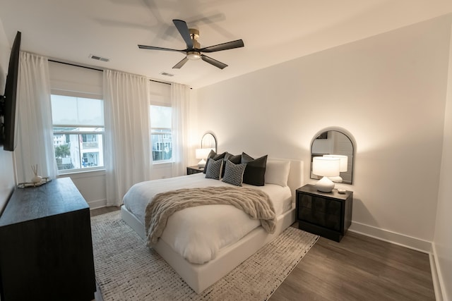 bedroom with ceiling fan and dark hardwood / wood-style floors