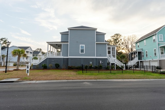 exterior space with a sunroom, a front yard, and a garage