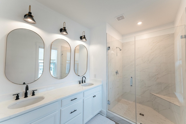 bathroom featuring vanity and an enclosed shower