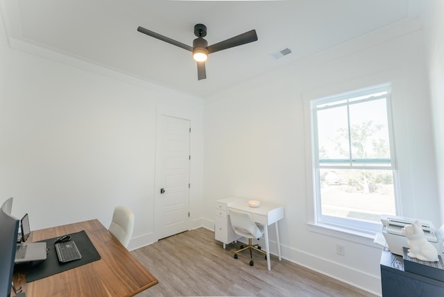 home office with crown molding, ceiling fan, light hardwood / wood-style floors, and a wealth of natural light