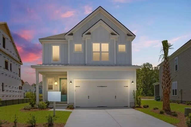 view of front of house with a garage and a yard