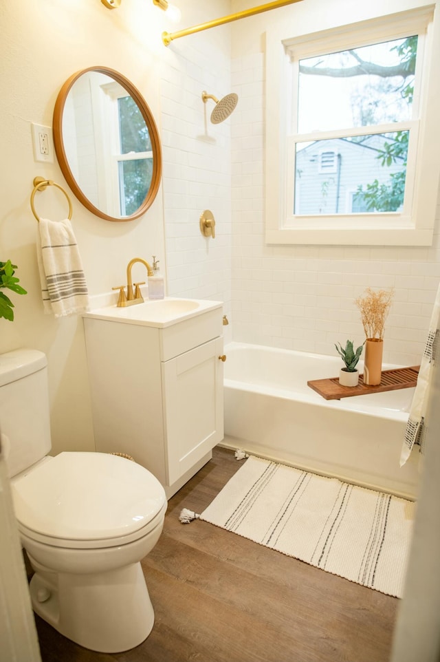 full bathroom with hardwood / wood-style floors, vanity, toilet, and shower / tub combo with curtain