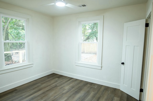 unfurnished room featuring ceiling fan and dark wood-type flooring